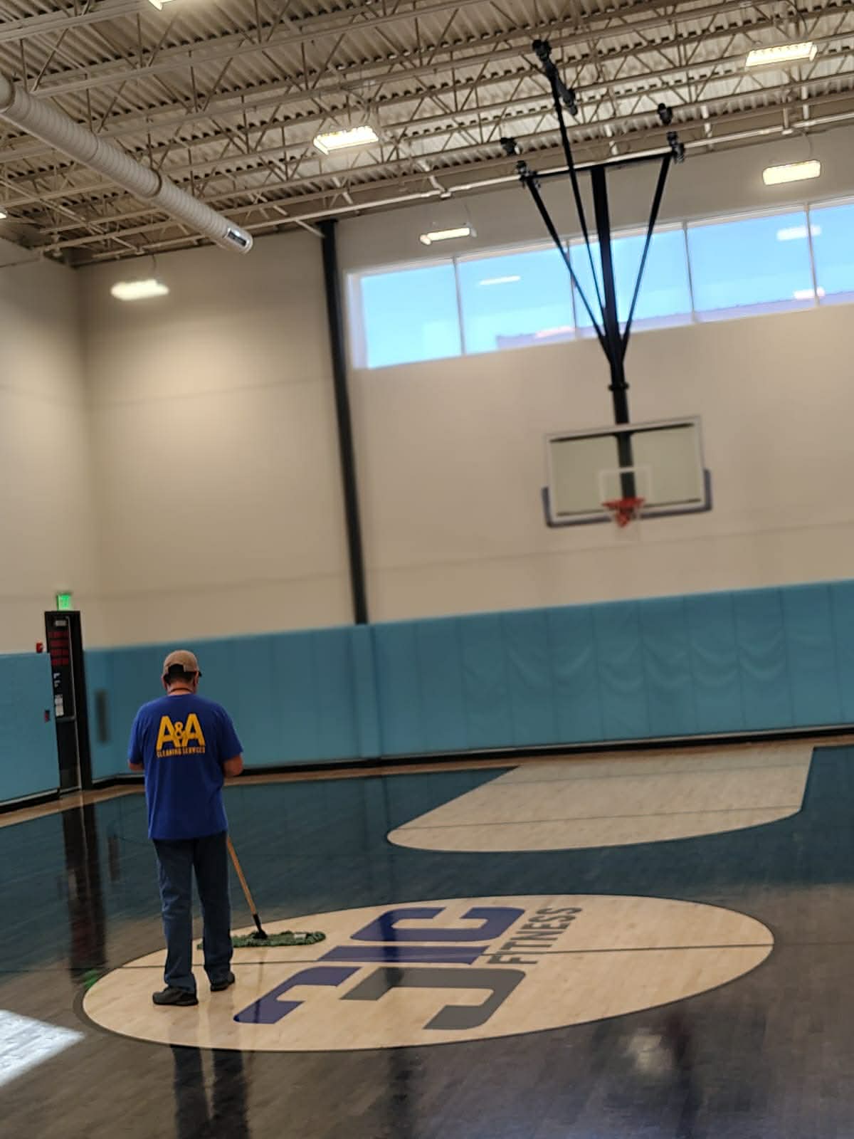 A&A Cleaning Services team member cleaning a commercial gym floor